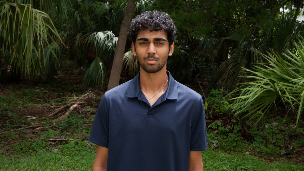 Headshot of Professor Nathan Thomas standing outside