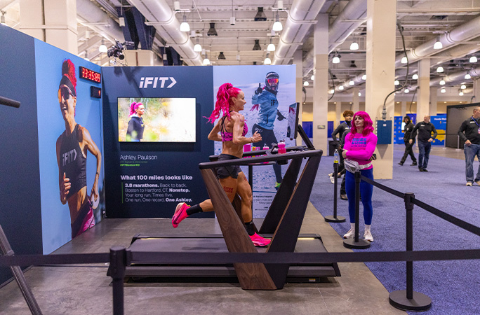 side view of Ashley running on a treadmill