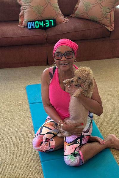 Annie on a yoga mat with her dog