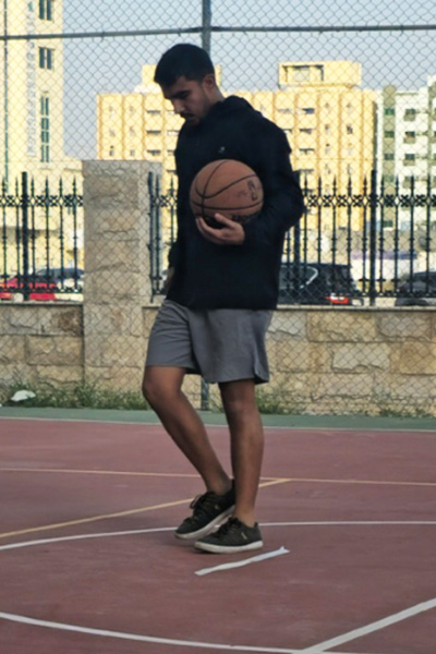 Hamed holding a basketball