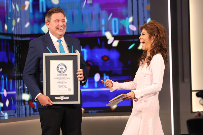 Michael and Julie Chen smiling onstage