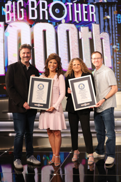 Closeup of the 3 executive producers and BB host holding their GWR certificates