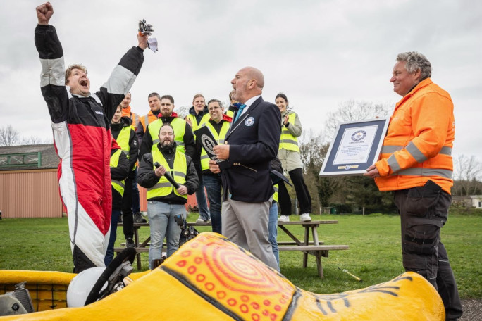 Kevin celebrating while Glenn approaches with a man with GWR cert