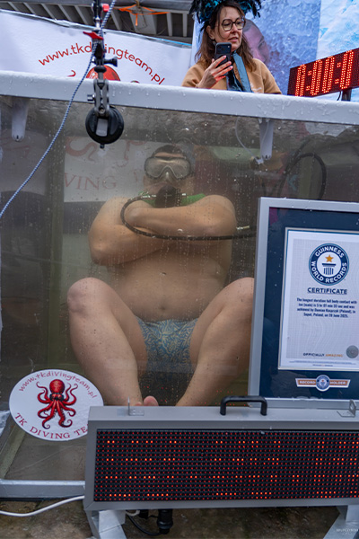 Damian sitting underwater with his arms crossed