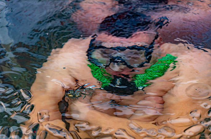 Damian seen from above sitting under the water