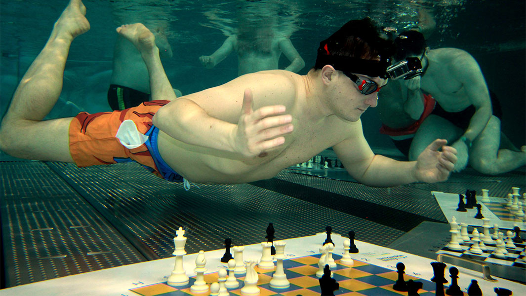 Michał playing chess underwater