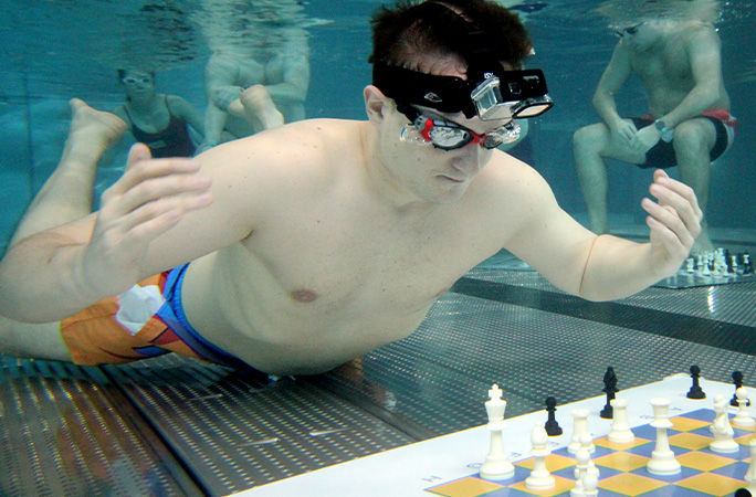 Michal playing chess underwater