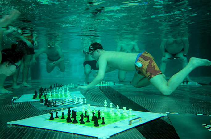 Michal playing chess underwater