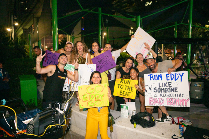 Eddy's supporters holding signs cheering him on