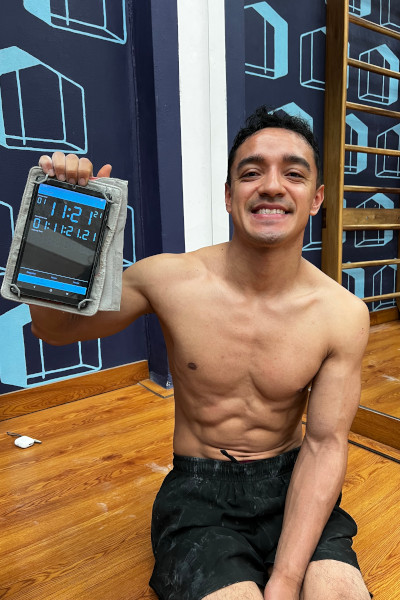 Santiago smiling with his timer after the attempt