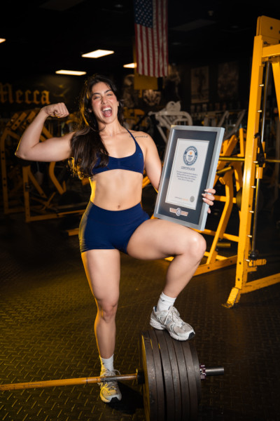 Lilian flexing and holding her GWR cert