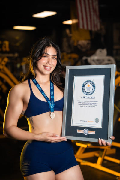 Lilian smiling and holding her certificate