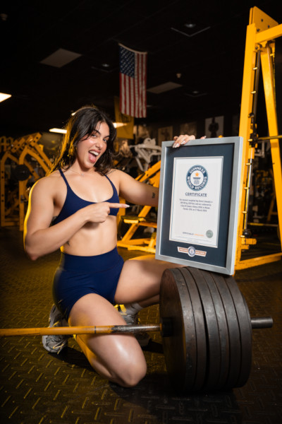 Lilian smiling at pointing at her GWR certificate
