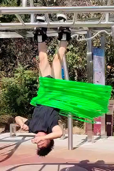 Yan hula hooping while hanging upside down