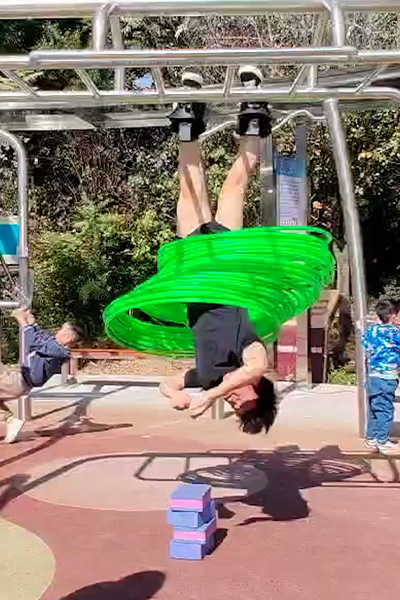 Yan hula hooping while hanging upside down