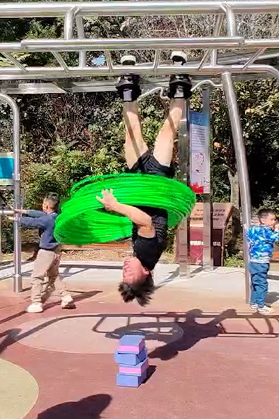 Yan hula hooping while hanging upside down