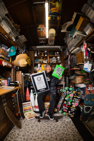 Judi holding her GWR2027 book and record, surrounded by skateboarding merchandise