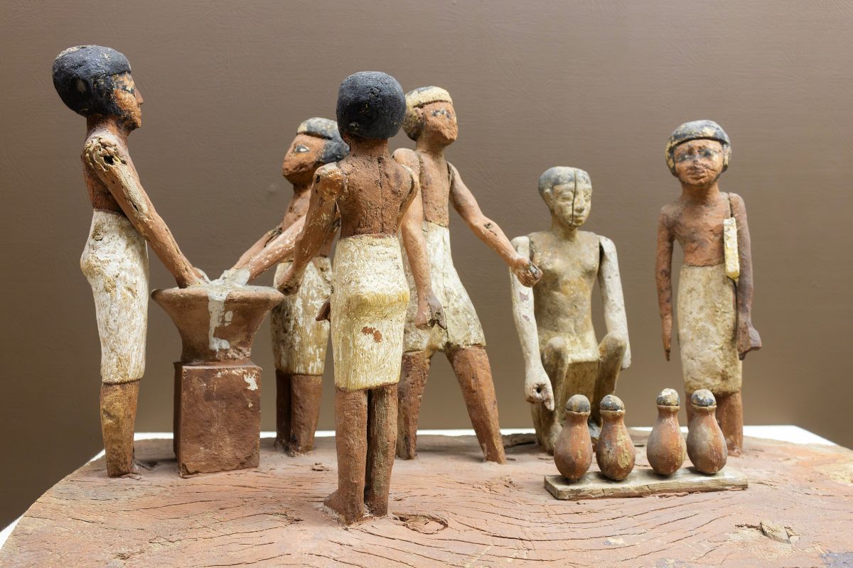 An ancient egyptian funerary model, showing a group of people brewing beer.