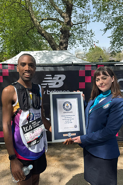 Matthew Akpan being awarded his GWR certificate by adjudicator Becki Ward
