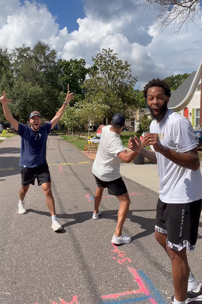 Nick celebrating while his friend looks shocked