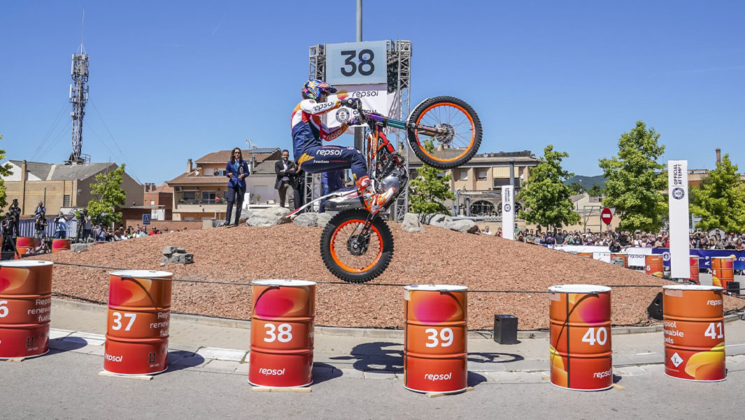 Toni Bou jumping between barrels on the rear wheel of his motorcycle