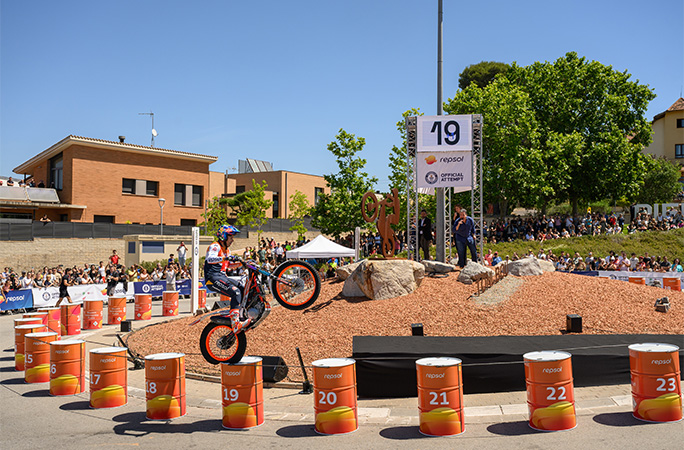 Toni jumping between barrels on his motorbike