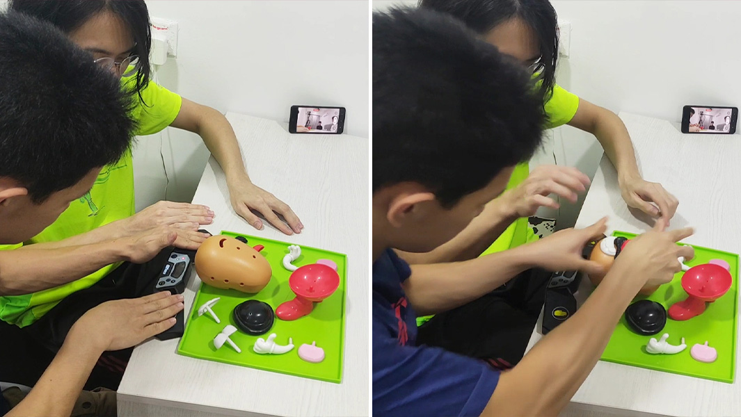 two people working together to build a Mr. Potato Head