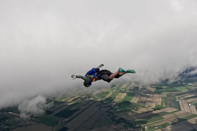 Mark-Olivier with his back parallel to the clouds and the earth below him