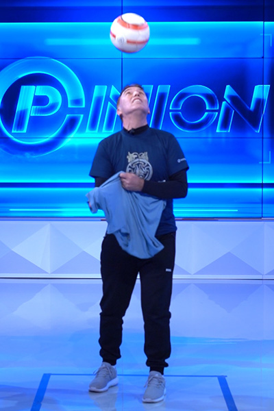 Agim pulling a T-shirt on while controlling a ball with his head