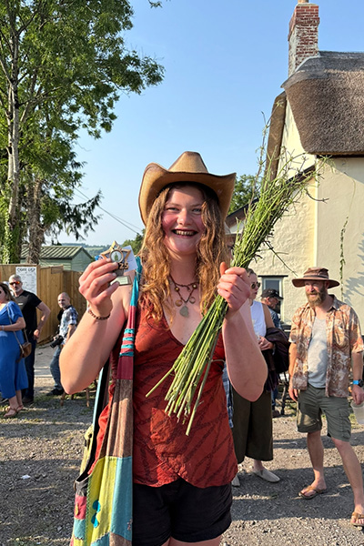 world-stinging-nettle-eating-championship-lucy-dermody-with-2025-trophy-and-stripped-nettle-stems