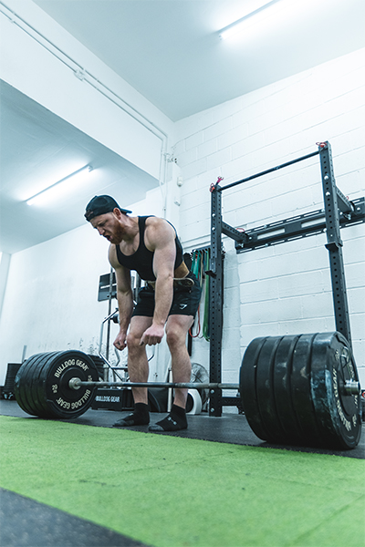 Daniel bending to lift the weight