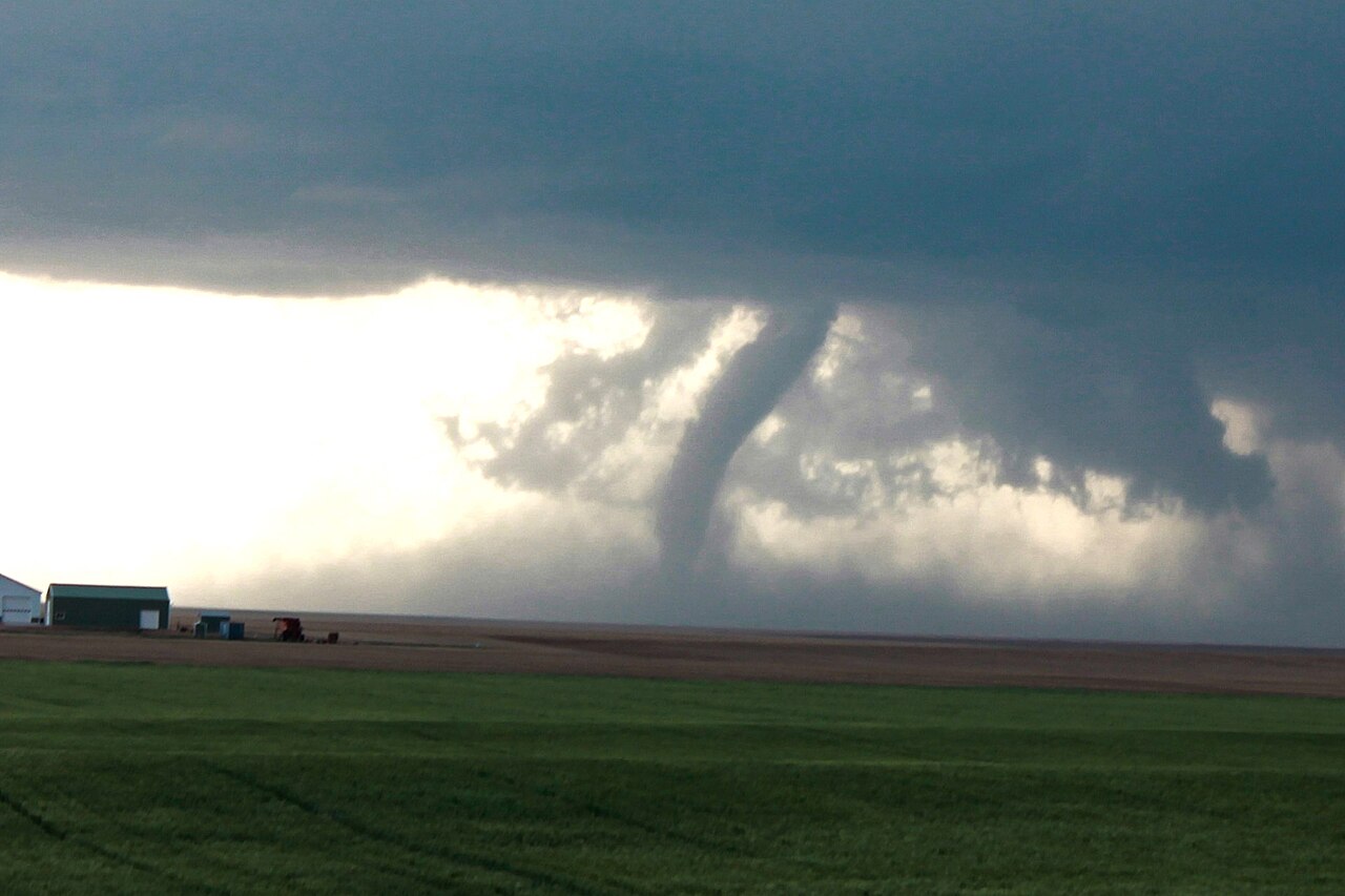 A tornado crossing fields.