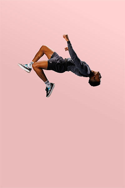 Fred doing a backflip against a pink background