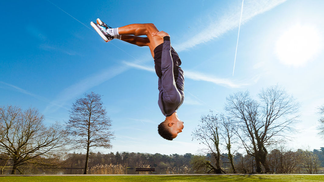 Fred upside down doing a backwards somersault