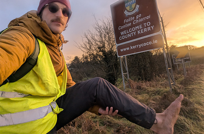 Eamonn holding up his bare foot in County Kerry