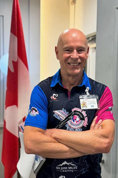 Headshot of Mark with the Canadian flag