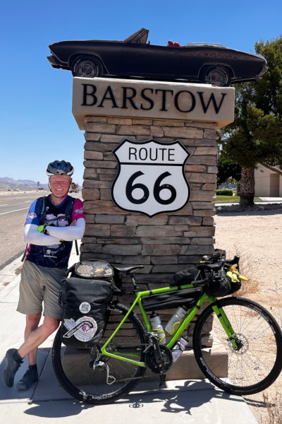 Mark next to an American Route 66 road sign