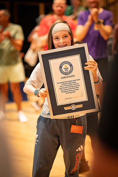 Bly holding her certificate