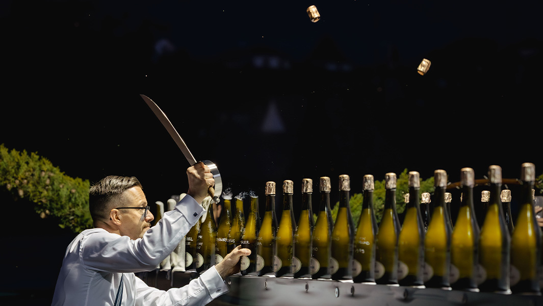 Mirko sabering bottles of champagne