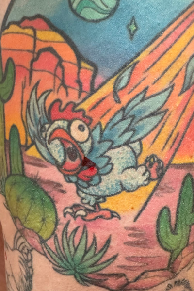 Closeup of Ashley's alien abduction chicken tattoo