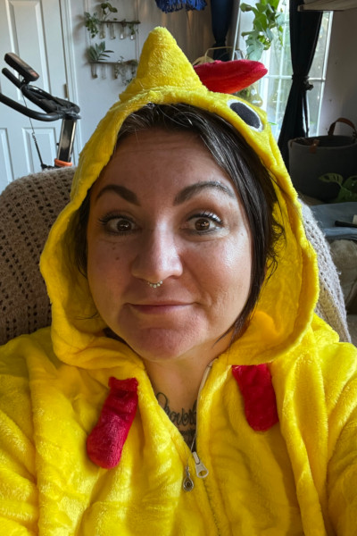 Ashley wearing a chicken onesie