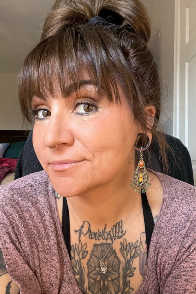 A selfie of Ashley with her neck tattoos