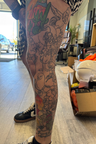 Ashley's right leg showing all her chicken tattoos