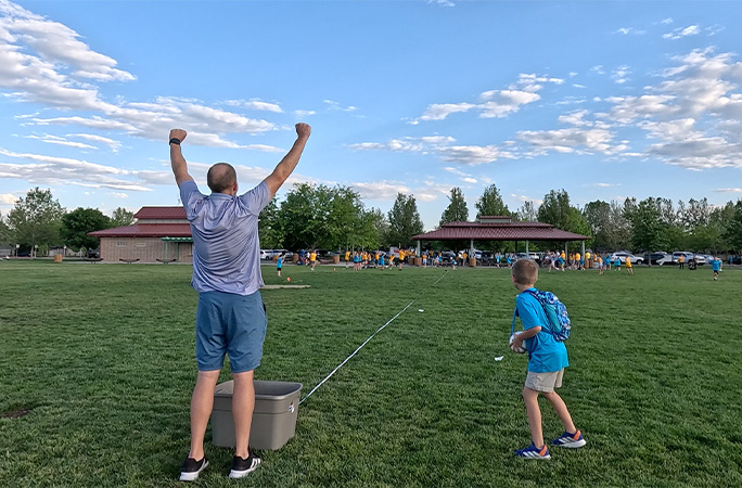 David celebrating with his arms in the air
