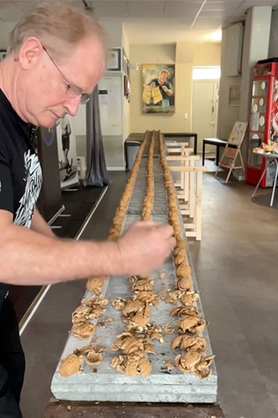 Muhamed crushing walnuts with his hands