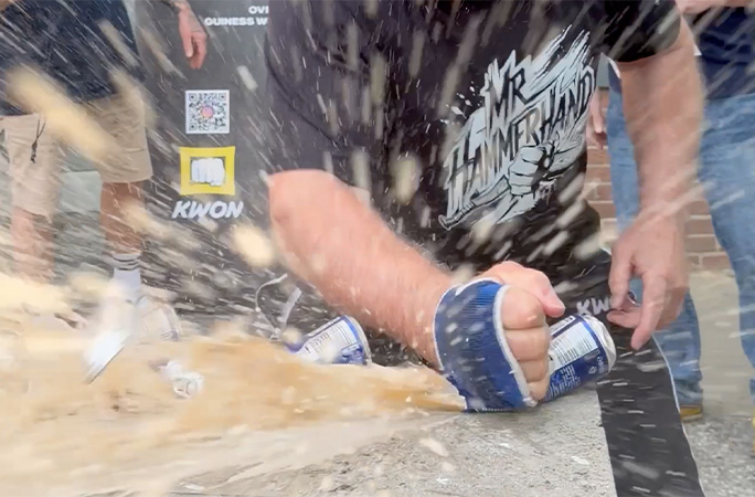 Muhamed smashing cans with his hands