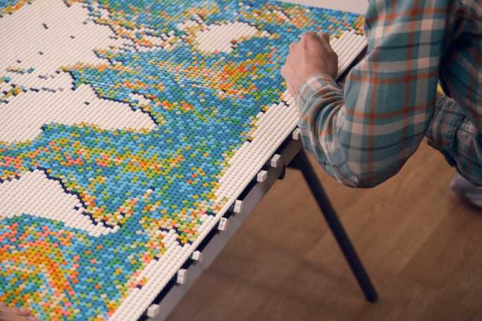 Closeup of Sevy's hand placing tiles on the map