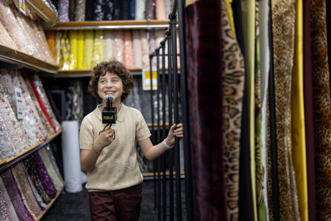 Max smiling next to his fabric line