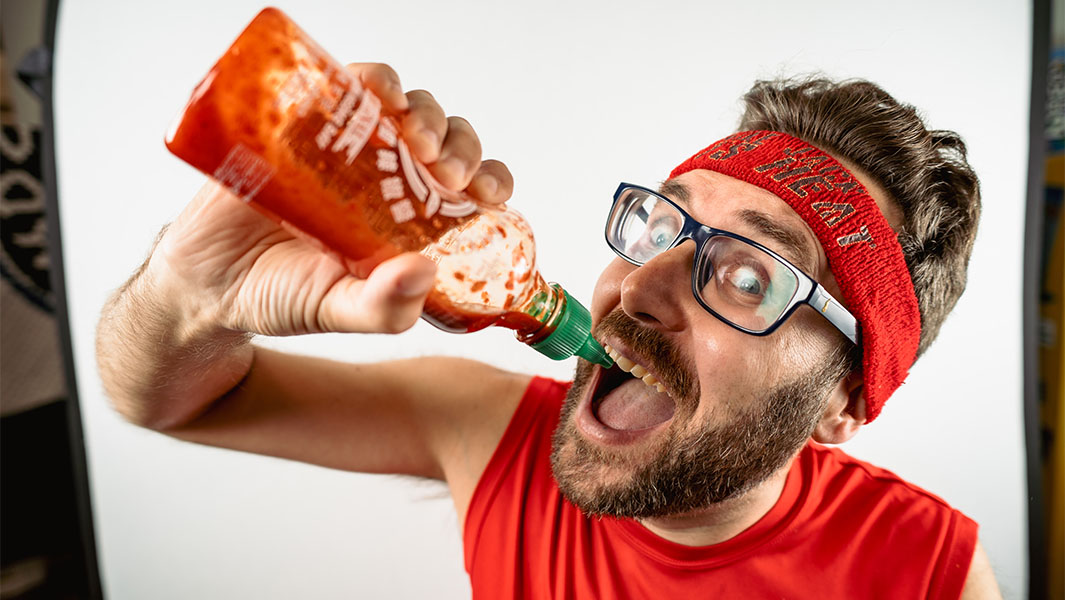 Mike Jack pouring hot sauce into his mouth