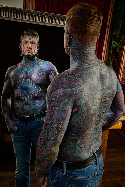 Tattooed Remy looking in a mirror